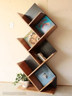 a bookshelf made out of wooden shelves with pictures on it