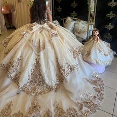 a woman in a wedding dress looking at herself in the mirror