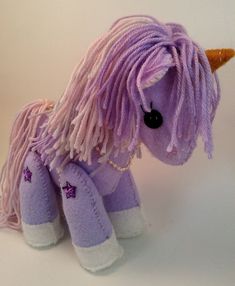 a purple stuffed pony with long hair