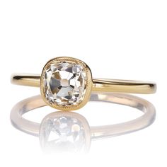 a gold ring with an oval cut diamond in the center and a thin band around it