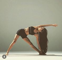 a woman is doing yoga on a mat