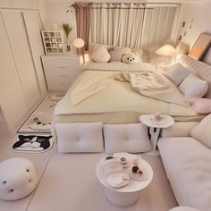 a bed room with a neatly made bed and lots of pillows on top of it