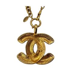 We are offering this rare Chanel Vintage Quilted CC Pendant Necklace. From the 1970 collection by Gabrielle 'Coco' Chanel, this piece is finely crafted of gold-tone hardware and features a lengthy necklace with the classic 'CC' logo pendant in a quilt-engraved appearance. Luxury Collectible Medallion Necklace, Formal Gold Chain Necklace With Logo Charm, Luxury Gold-tone Jewelry With Logo Charm, Gold-tone Necklace With Logo Charm For Formal Events, Formal Gold-tone Necklace With Logo Charm, Vintage Gold-tone Necklace With Logo Charm, Luxury Gold-plated Jewelry With Gold-tone Logo, Designer Gold-tone Brass Jewelry, Designer Yellow Gold Jewelry With Logo