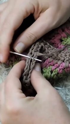 someone is crocheting something with their hands