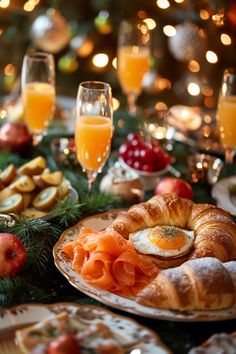 an assortment of food and drinks on a table in front of a christmas tree with lights