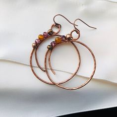 These gorgeous boho earrings are handcrafted from copper wire and glass beads. They would make the perfect gift or accent to any outfit! Earring Tutorials Free, Copper Wire Earrings Diy, Bohemian Hand Wrapped Copper Wire Earrings, Bohemian Hand-wrapped Copper Wire Earrings, Bohemian Brown Copper Wire Jewelry, Bohemian Dangle Hoop Earrings With Copper Wire, Bohemian Hoop Earrings With Copper Wire, Bohemian Wrap Earrings With Copper Ear Wire, Bohemian Wire Dangle Jewelry