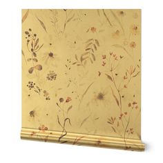 a wallpaper with flowers and leaves painted on it's side, in gold