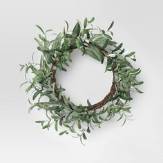 a wreath with green leaves and branches