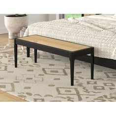 a coffee table sitting on top of a rug next to a bed