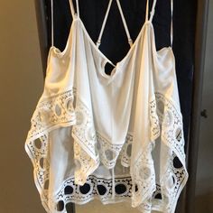 White With Multiple Spaghetti Straps And Adjustable Straps. Detailed Around The Bottom. No Tags But Never Worn Flowy White Top For Beach Cover-up, Bohemian Cami Top For Vacation, Beach Season Camisole For Day Out, Summer Beach Cami Top, Flowy Cami Camisole For Beach, Chic Cami Top For Beach, White V-neck Camisole For Beach, Flowy Beach Camisole, Summer Cami Tops For Daytime