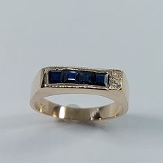 This Handmade Sapphire and Diamond Ring has been carefully crafted in 10k Yellow Gold, Authentic White Diamonds  and Authentic Sapphire. This delicate ring would make an amazing birthday/any occasion gift. Ring will be shipped to you in an elegant gift box and it can resized at no extra cost. Once the ring has been mailed a tracking shipping number will be provided to you. Sapphire Measurements: 4 Sapphire: 2.5 mm x 2.5 mm Diamond Measurements: 2 Diamonds, each stone is 1.5 mm, 0.015 cts, total Gold Sapphire Rings With Princess Cut, Blue 14k Gold Ring Stamped 14k, Blue 14k Stamped Promise Ring, 14k Gold Blue Diamond Ring, 14k Stamped Sapphire Rings Round Cut, 14k Stamped Sapphire Ring With Round Cut, Blue 14k Gold Rings For Anniversary, Sapphire Ring Stamped 14k Round Cut, Formal Three Stone Sapphire Ring In 14k Gold