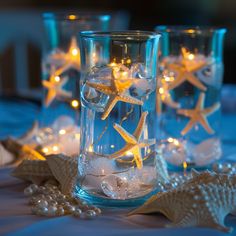 starfish lights in glass vases filled with water