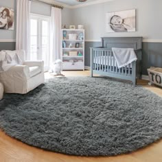 a baby's room with a gray rug and white crib in the corner