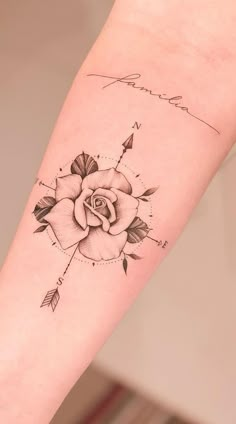 a rose tattoo on the arm with an arrow