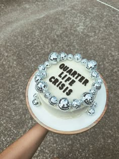 a cake that has been decorated with silver balls and the words whatever else is on it