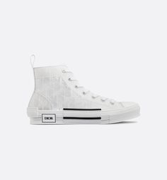 The B23 high-top sneaker is set apart by its layering of transparent paneling and white Dior Oblique canvas. Essential details, such as eyelets and a lace-up front, a white rubber sole, a rounded and reinforced toe as well as a rear tab recall the codes of the classic high-top style. The sneaker is further enhanced with contrasting details on the sides, including a Dior signature, and pairs easily with any casual outfit.. Givenchy Jacket, Versace Jacket, Louboutin Bags, Off White Jacket, Burberry T Shirt, Dior Oblique, Set Apart, Hype Shoes, Newest Jordans