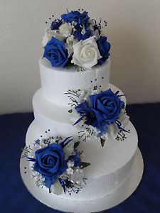 three tiered wedding cake with blue and white flowers