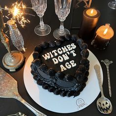 a cake with the words witches don't age written on it and some silverware