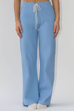 a woman wearing a light blue pants with a white top and white sneakers Wide Leg Lounge Pants, School Wear, Color Crema, Brand Collection, Jacket Brands, Fall Collections, Lounge Pants, Luxury Shoes, Skirt Pants