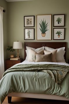 a bedroom with green walls and pictures on the wall above the bed, along with two lamps