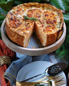 a cheese and onion quiche on a wooden platter