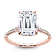 an emerald cut diamond engagement ring with pave set shoulders