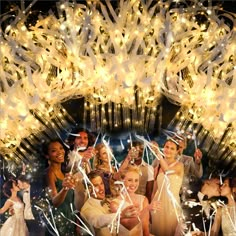 a group of people standing next to each other holding up champagne flutes and confetti