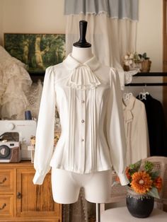 Add a touch of Victorian elegance to your wardrobe with this white long-sleeve shirt featuring a detachable jabot on the neckline. Perfect for adding a sophisticated and gothic twist to your outfit, this versatile piece can be dressed up or down for any occasion.This price includes a shirt and a detachable jabot. Frilled Dress, Steampunk Fashion Male, White Goth, Gothic Skirts, Pin Up Dresses, White Long Sleeve Shirt, Ruffle Shirt, Outfits With Hats, Steampunk Fashion