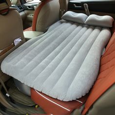 an inflatable car seat with pillows on it