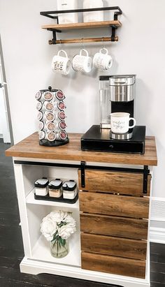 a coffee maker on top of a wooden cabinet