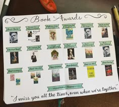 a book award is displayed on top of a notepad with pens and scissors next to it