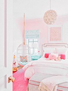 a bed room with a neatly made bed and a pink rug