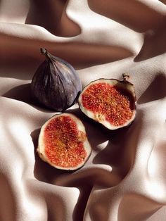 two figs sitting on top of a white cloth