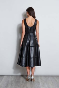 Meet our modern, endlessly versatile Fit & Flare Dress in luxe Vegan Leather that's infused with a chic vibe. The feminine self-belt & tiered midi skirt give it the cool factor whether worn with pumps or dressed up with strappy heels for night. Vegan Leather Belted Midi Fit & Flare Dress 100% Polyester Runs true to Size Model is 5'9" and wearing size 2 Dry Clean Only Imported Style #: ETR44228