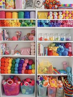 the shelves are filled with many different types of yarn