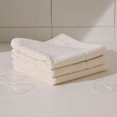 three white towels stacked on top of each other