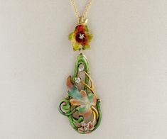 "One word....Colorful! This is a wonderful conversion Art Nouveau piece from its original brooch form. Now a necklace, and much more wearable in this day and age. The setting is a very bright 14k yellow gold, featuring gorgeous enamel work in a multitude of colors as can be seen in our photos. A curvy foliage motif, which was very much coveted during this jewelry design era. Sparkling from within this decorative piece are both rose and mine-cut diamonds. Antique Necklace - Antique Art Nouveau 14 Artistic Enamel Jewelry For Formal Occasions, Art Deco Multicolor Jewelry For Gift, Multicolor Art Deco Jewelry For Gift, Multicolor Art Deco Jewelry Gift, Artistic Multicolor Jewelry For Wedding, Artistic Multicolor Wedding Jewelry, Artistic Formal Brooch Jewelry, Artistic Multicolor Jewelry For Formal Occasions, Artistic Multicolor Jewelry For Formal Events