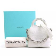 Auth Tiffany&Co. Return To Tiffany Handbag Crossbody Bag White/Silver Description This Is A Guaranteed Authentic Tiffany&Co. Return To Tiffany Crossbody Shoulder Bag. Please Check Photos Carefully Before Buying The Item. Brand Tiffany&Co. Style Crossbody Shoulder Bag Color White Material Leather Size [Inch] W:4.3inx H:3.9inx D:2.6in Handle Length:5.1in Shoulder Length: 40.9in Size [Cm] W:11cmx H:10cmx D:6.5cm Handle Length:13cm Shoulder Length: 104cm Specifications Magnet Button Closure Comes Wi Tiffany Handbag, Tiffany White, Return To Tiffany, Dust Cover, White Bag, White Material, Shoulder Length, Tiffany & Co., White Silver