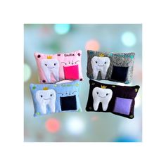 three tooth shaped pillows are shown on a blue and white bouncy blurry background