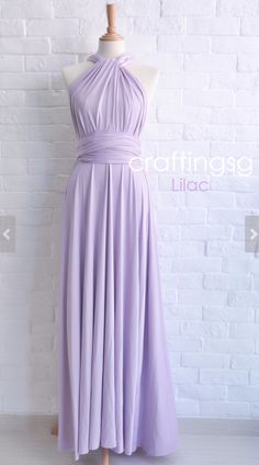 a dress on a mannequin stand in front of a white brick wall with the words crafting lilac