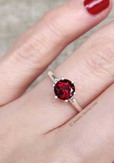 ------------------------------------------------------- Brilliant Cut Garnet Ring THE PRODUCT - This is an extremely unique vibrant brilliant cut round garnet ring. We hand selected each individual stone to make sure they are radiant and full of color. - The cut style known as 'brilliant' makes it catch every ray of light and reflect it back making this stone extremely bright and radiant for a natural garnet! - What makes this garnet ring so unique is the mesmerizing glow and bright red hues it Pink Gold Rings, Moss Agate Jewelry, Red Gemstone Ring, Blue Sapphire Studs, Gemstone Engagement Ring, Ray Of Light, Agate Engagement Ring, Moss Agate Ring, Diamond Quartz