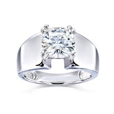 a white gold ring with a diamond in the center and two diamonds on each side