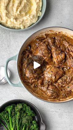 a pot filled with meat and broccoli next to mashed potatoes on a table