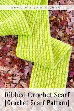 the ribbed crochet scarf is laying on top of leaves and has text overlay that says ribbed crochet scarf