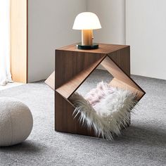 a lamp that is on top of a small table in the middle of a room