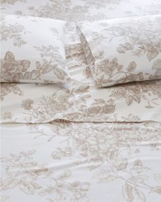 an image of a bed with white and brown flowers on the comforter sheet set