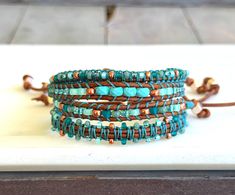 the turquoise and brown beaded bracelets are stacked on top of each other