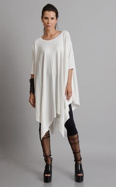 Oversize Long Tunic - METT0105 Be modern in white with this maxi tunic. Because of the loose fit, this top is super easy to wear and perfect for an every day use. It has beautiful asymmetric draping and can easily be paired with a lot of different pants and leggings. Put a pair of heels and a few accessories to make the outfit whole. This asymmetric tunic is made of 100% cotton. NOTE! The color is off white! WHEN YOU PLACE AN ORDER YOU MUST LEAVE A TELEPHONE NUMBER AND CORRECT COORDINATES! WE DO Oversized White Blouse For Layering, Casual Flowy Half Sleeve Tops, Flowy Half Sleeve Casual Tops, White Relaxed Fit Half Sleeve Blouse, Flowy White Blouse For Layering, Summer Batwing Sleeve Lagenlook Tops, Summer Lagenlook Tops With Batwing Sleeves, White 3/4 Sleeve Tops For Layering, Lagenlook Short Sleeve Blouse For Fall