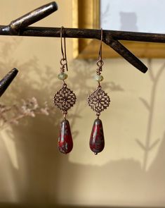 "Details & measurements: ~ Earthy deep red and swirling sea green Czech glass teardrop beads with Picasso finish (20 x 10mm) dangle from beautifully detailed, dainty antique copper filigree charms (13 x 17mm)  ~ Accented with Czech glass rondelle beads in light green w/ rustic Picasso finish (3 x 5mm) ~ They hang from antique copper ear wires ~ Earrings hang almost 2 3/4\" long ♡ Packaged safely & sustainably in a kraft box with cotton ribbon & dried organic florals. This makes for a beautiful gift, or something pretty for yourself! All packaging materials are zero waste and also reusable. ♡ As well, we always aim to ship with plastic-free packing materials. Sustainability is an integral part of our lives, and we bring that same dedication to our small business." Bohemian Copper Wire Wrapped Teardrop Earrings, Adjustable Copper Teardrop Bohemian Earrings, Bohemian Bronze Teardrop Earrings Gift, Bohemian Teardrop Copper Wire Jewelry, Handmade Brown Bohemian Teardrop Earrings, Bohemian Hypoallergenic Bronze Earrings, Bohemian Bronze Hypoallergenic Earrings, Hypoallergenic Bohemian Bronze Earrings, Nickel-free Bohemian Brown Teardrop Earrings