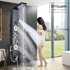 a woman standing in front of a shower with water coming out of the faucet